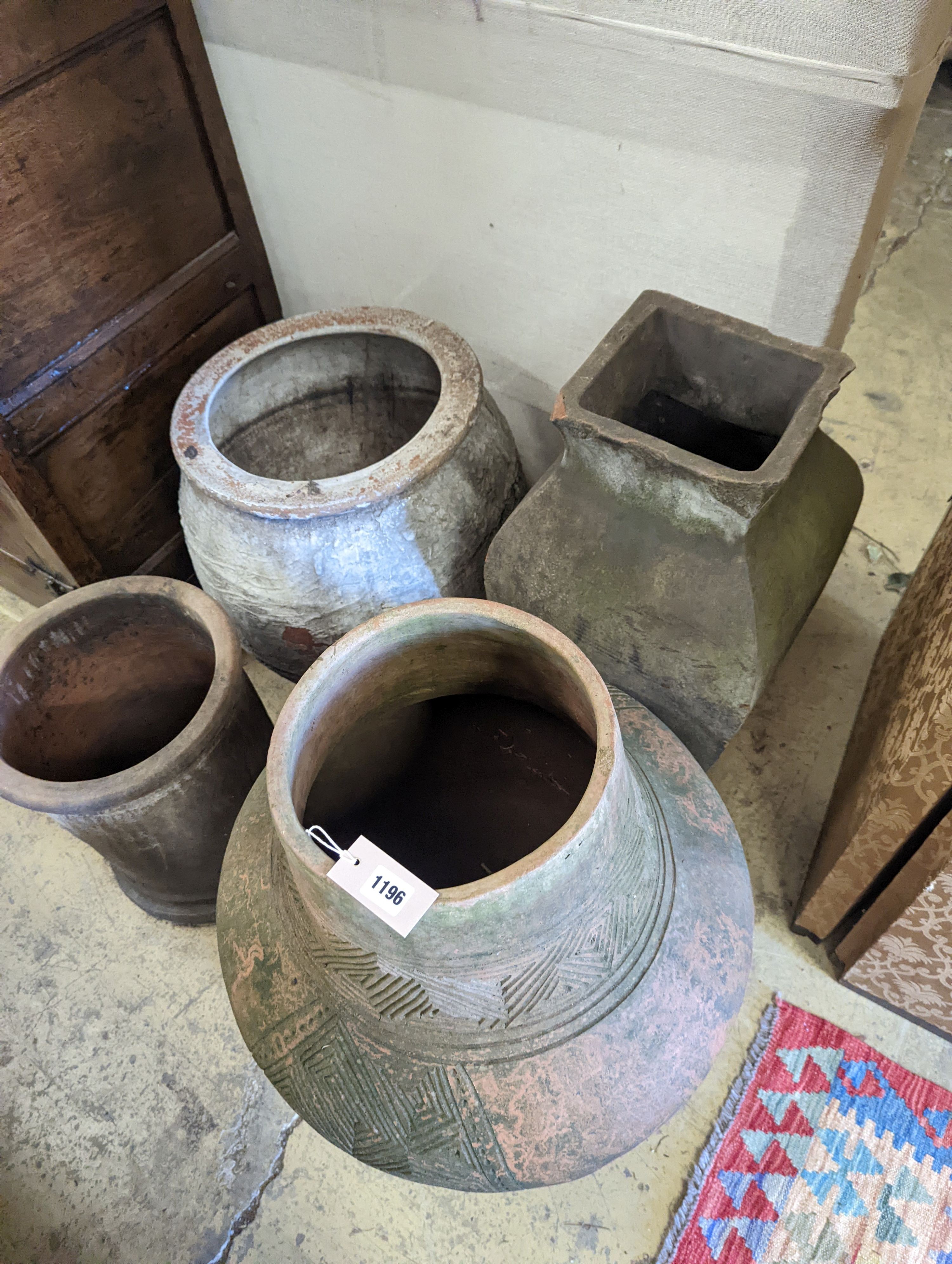 A large incised terracotta garden urn, height 72cm together with three other large earthenware garden urns